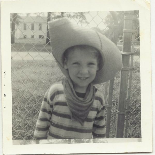 Bobby as a young boy wearing a cowboy hat